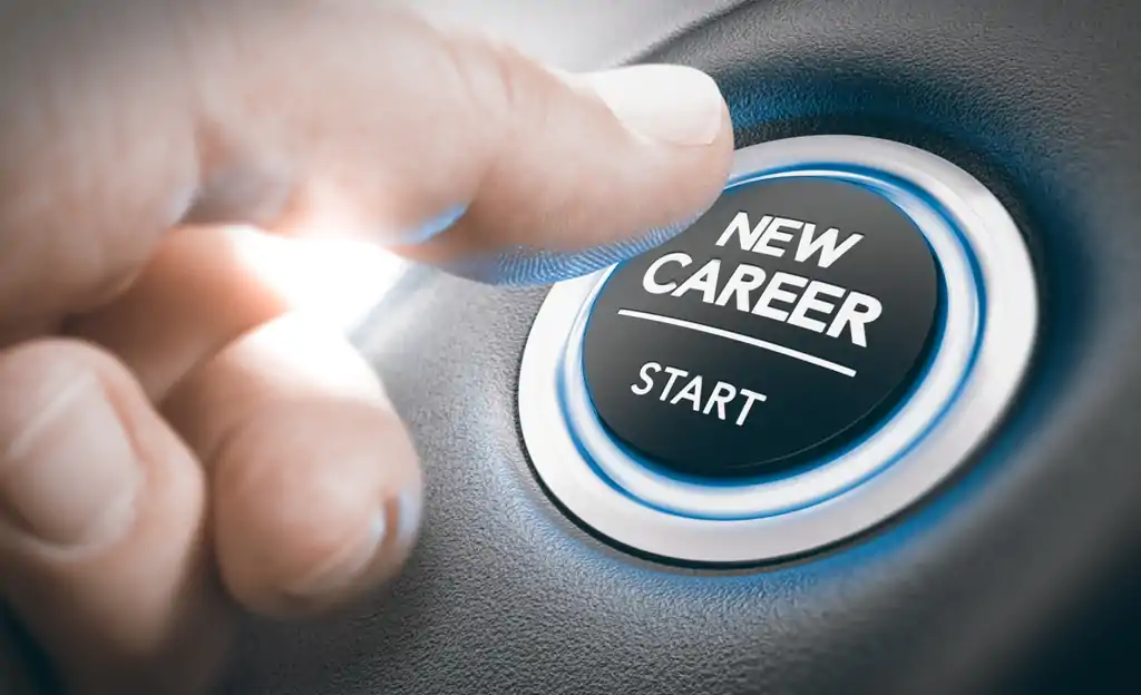 A hand pressing a button that says, "NEW CAREER | START."